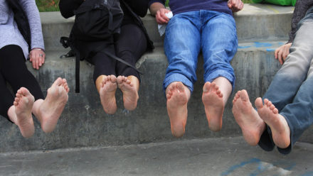 people sitting and showing their bare feet